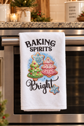 Baking Spirits Bright holiday microfiber kitchen towel with sugar cookie Christmas tree design, hanging on a stainless steel oven.