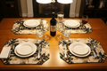 Wine quilted placemats styled on a dining room table with wine glasses and bottle