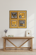 Bee-themed quilted wall hanging displayed on a white wall in a cozy cottage interior